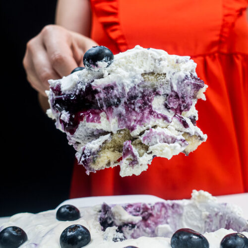 A big portion of blueberry tiramisu in Helena's right hand