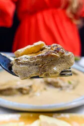 Helena is trying a creamy steak on a fork