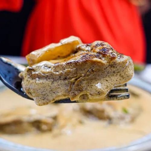 Helena is trying a creamy steak on a fork