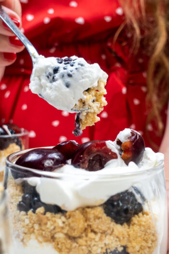 Helena is trying cheesecake with one teaspoon full of berries