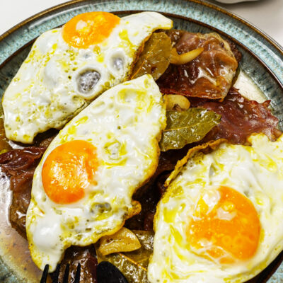 Portuguese Bitoque Steak with fried egg on a green plate