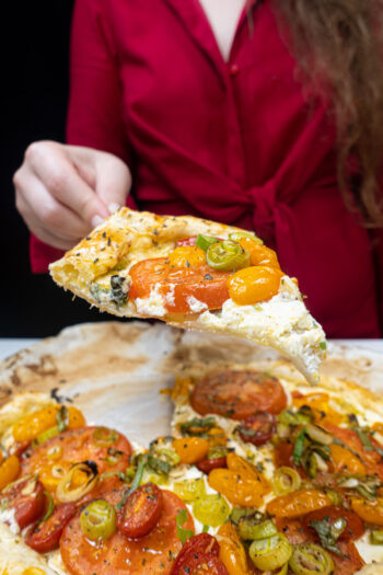 Helena is holding one piece of tart in the right hand