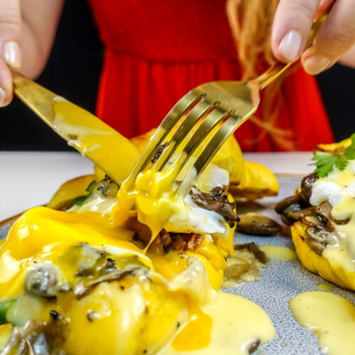 Helena is cutting croissant with truffles and hollandaise sauce