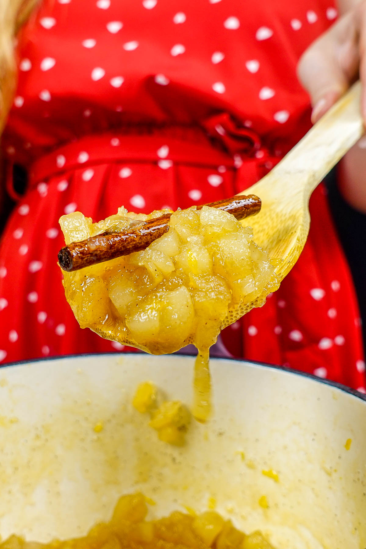 Helena is holding a spoon of pear jam with cinnamon