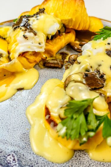 A closeup of delicious Truffle Mushroom Eggs Benedict