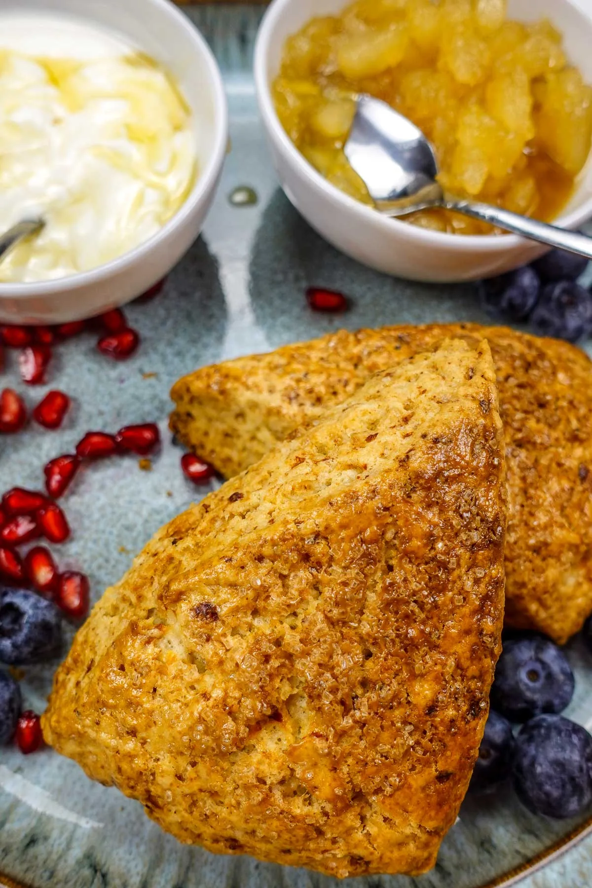 A closeup of two big cottage cheese scones on a plate.