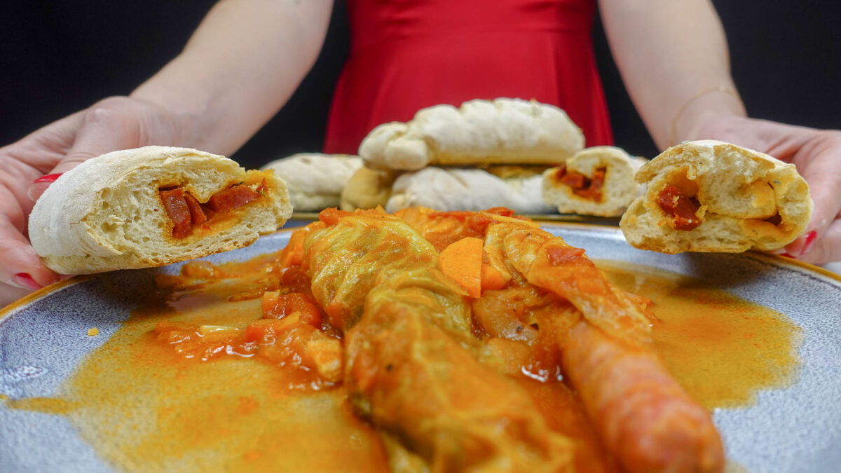 A plate with ready chorizo bread loaves and Helena is standing behind the plate