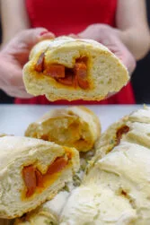 Helena is holding one chorizo bread and a plate of freshly baked chorizo bread