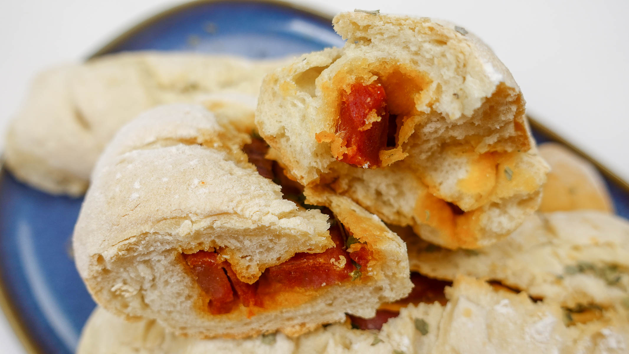 Chorizo bread loaves on a blue plate