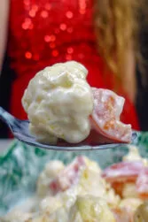 Helena is holding one teaspoon of fresh salad