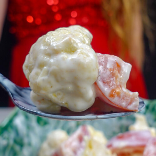 Helena is holding one teaspoon of fresh salad