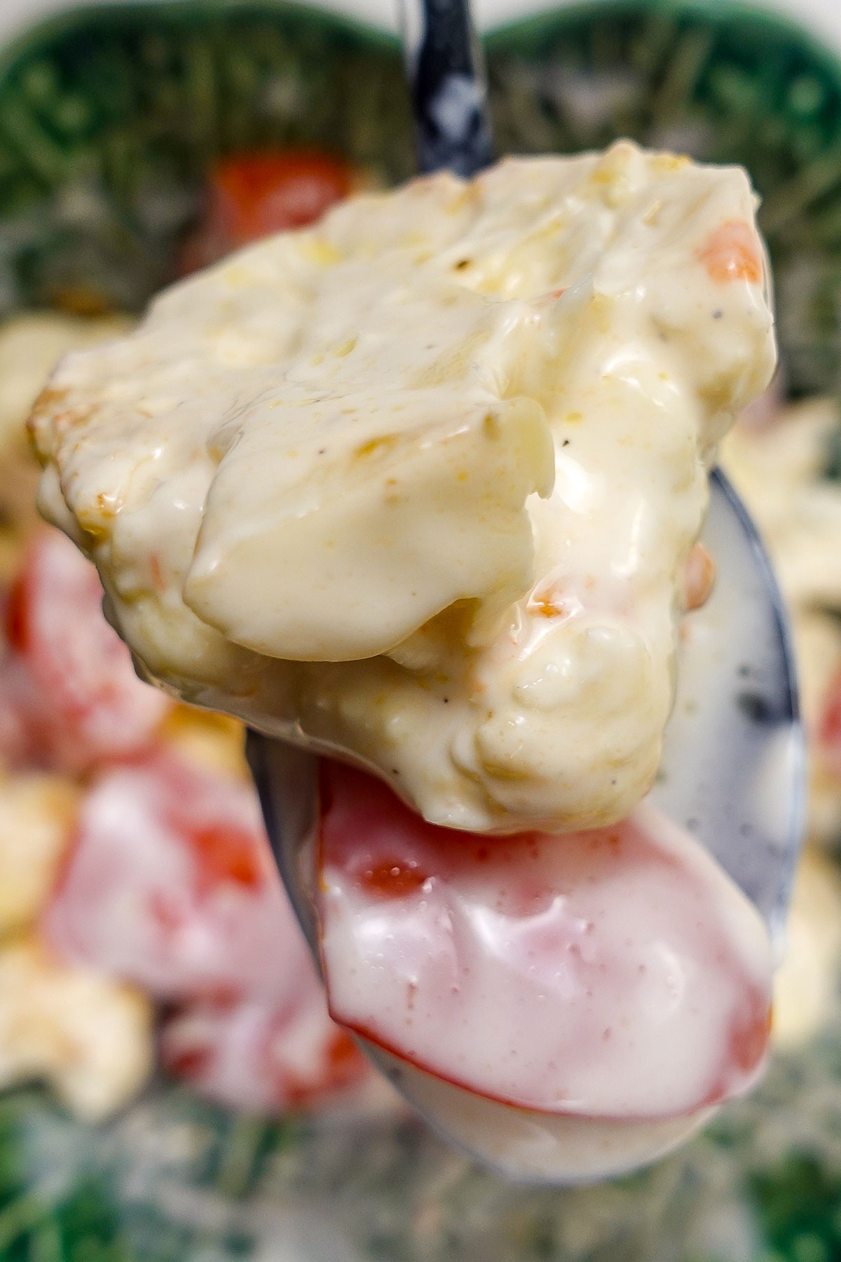 A big spoon of Creamy Cauliflower Salad with cherry tomatoes