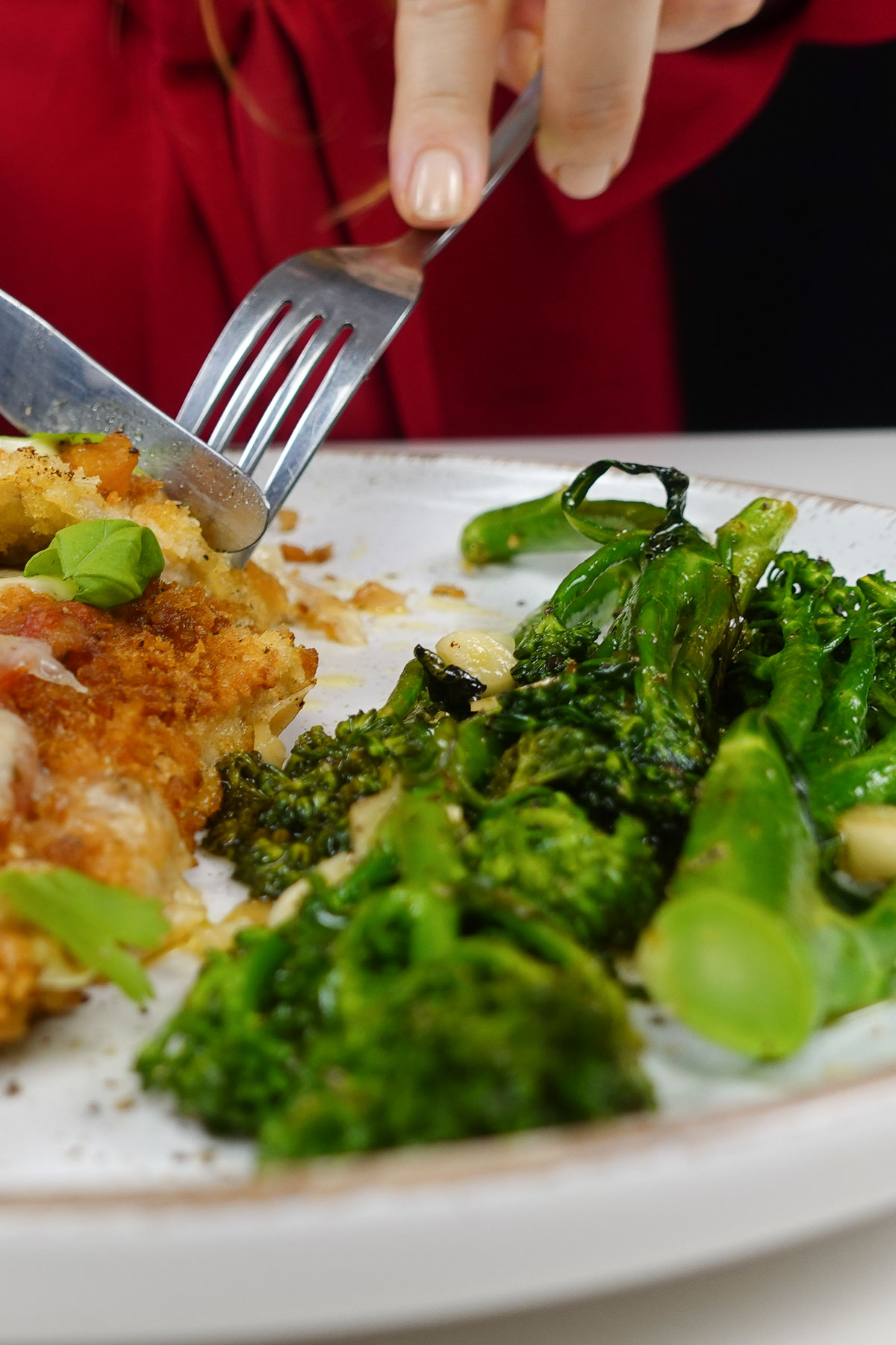 Helena is trying delicious meal with broccolini