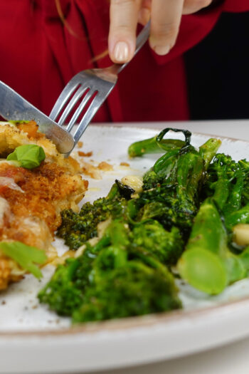 Roasted garlic Broccolini on a white plate