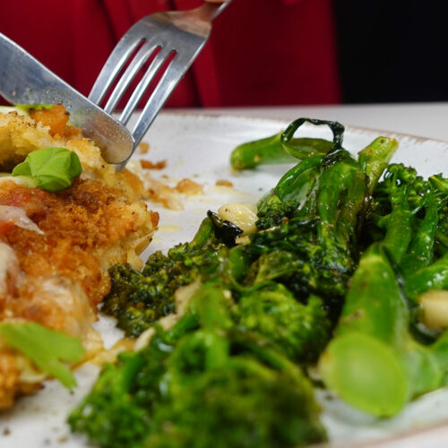 Roasted garlic Broccolini on a white plate