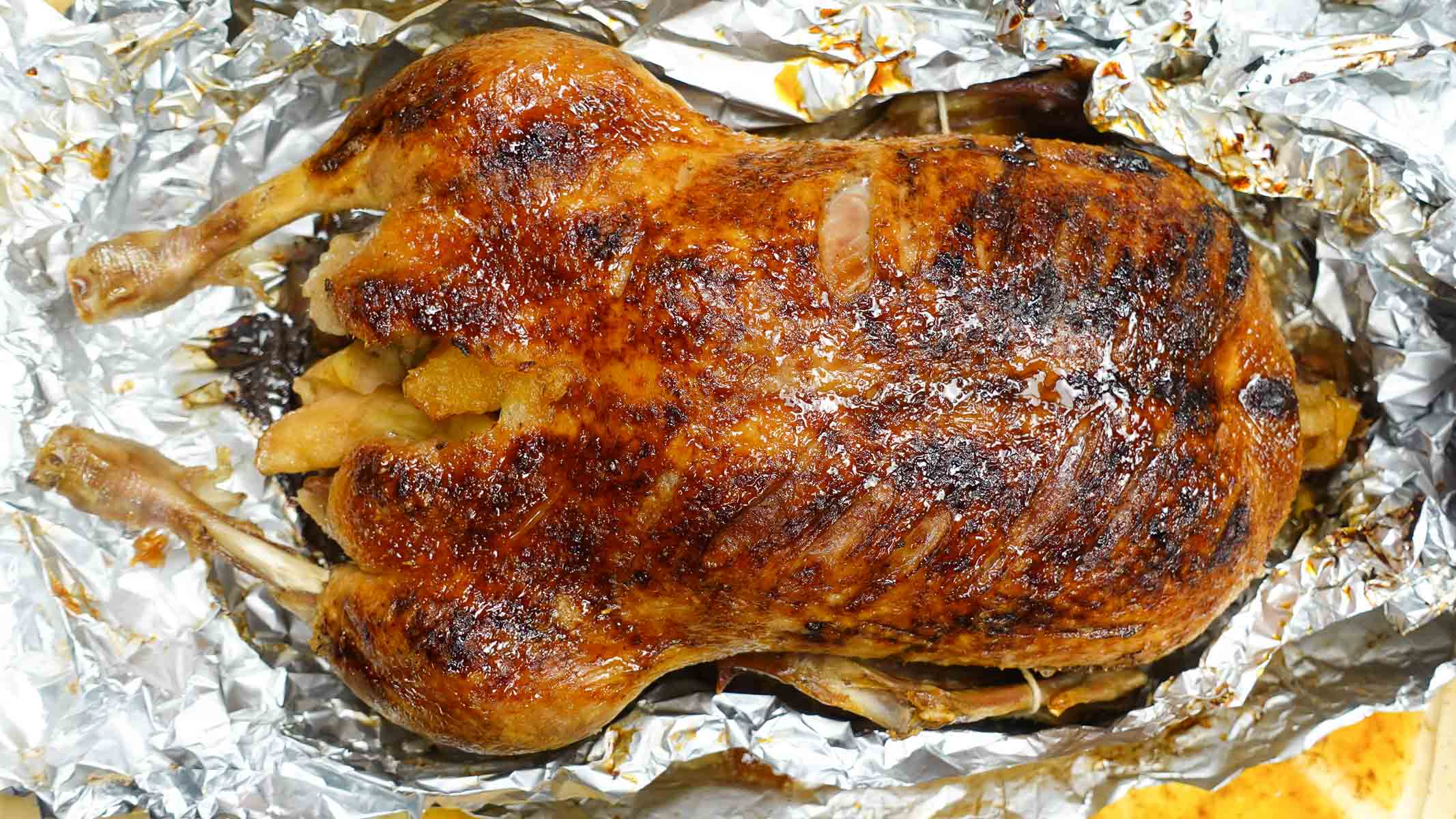 The photo overhead of golden brown roast duck on a tray