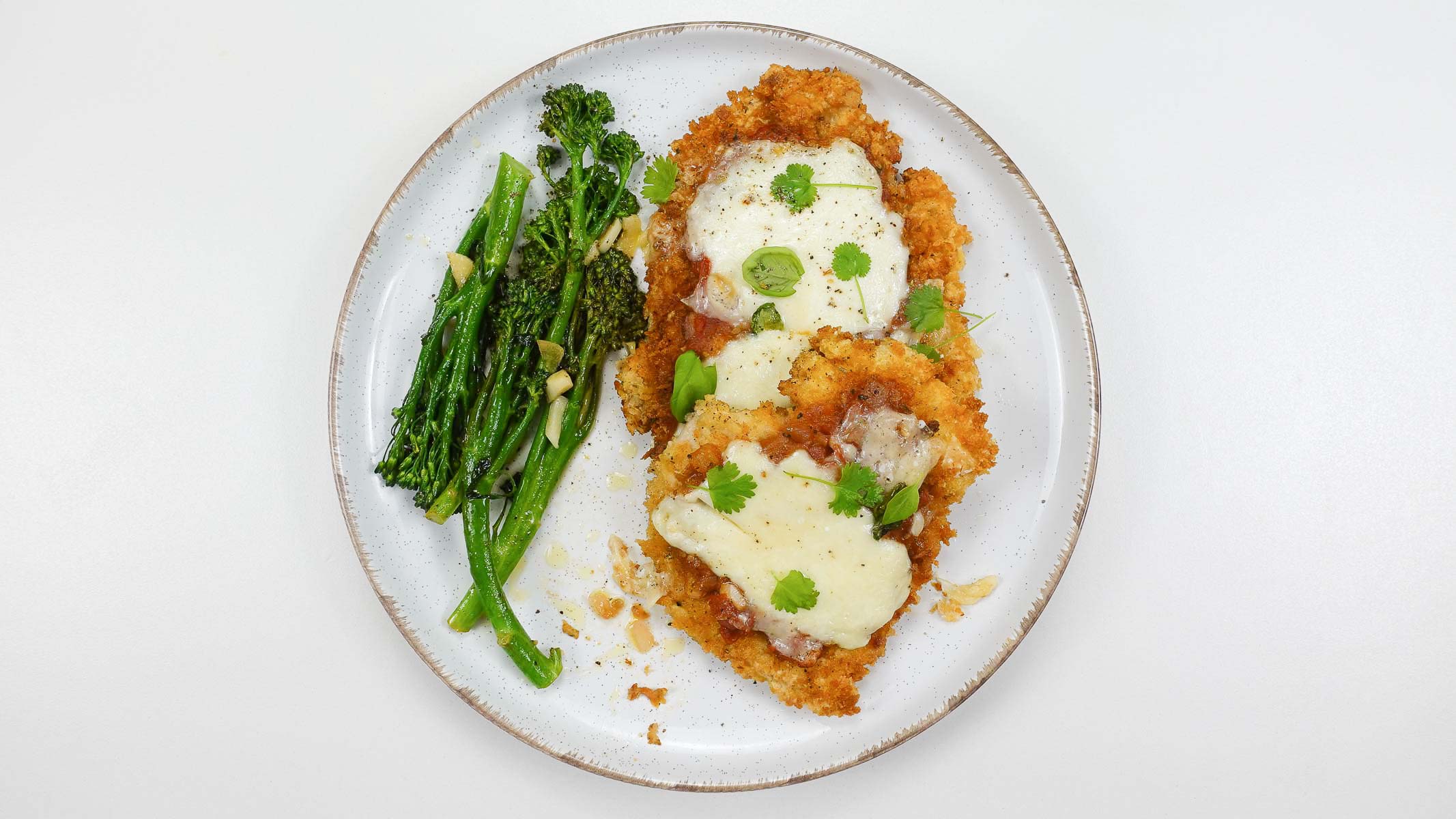 Delicious garlic broccolini with turkey on a side on a white plate