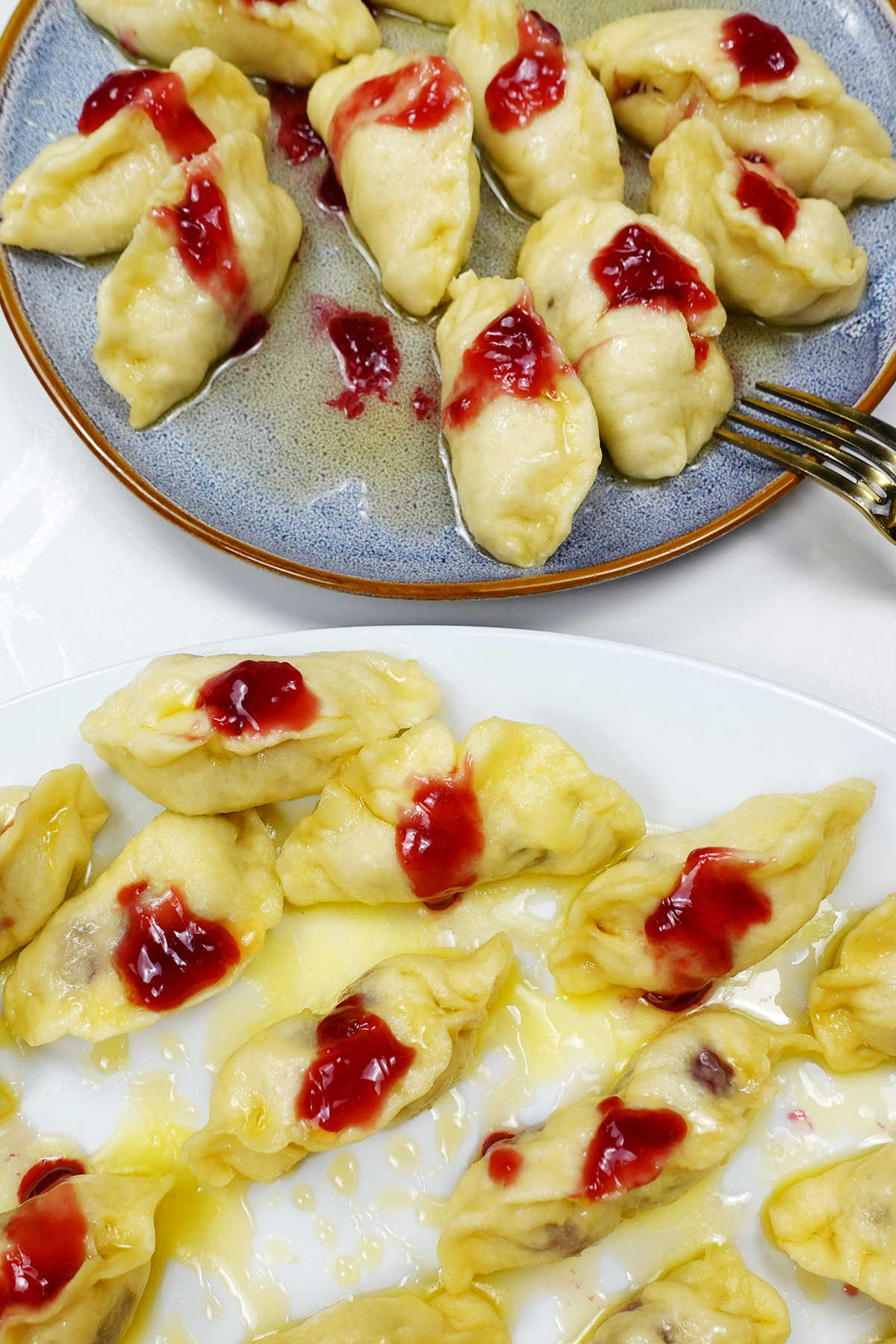 Two plates blue and white with cherry dumplings