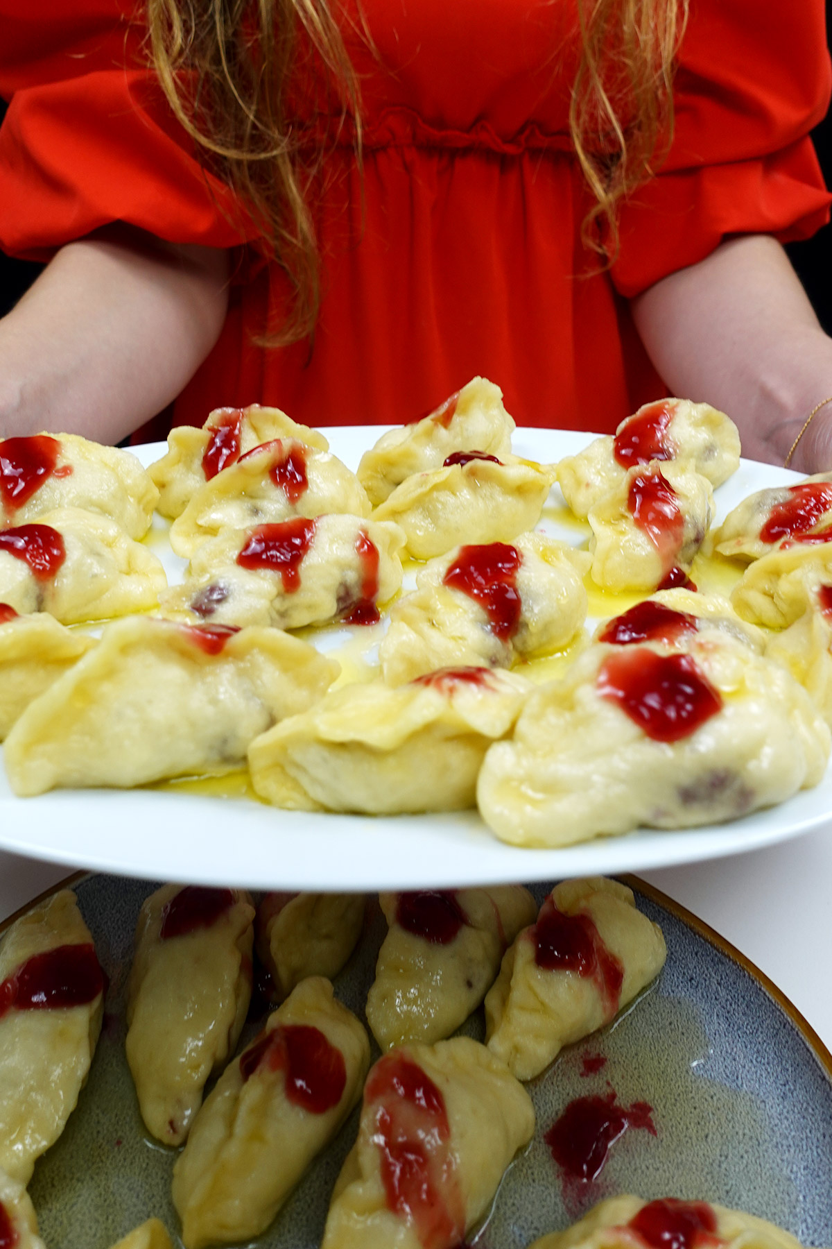 A plate with cherry dumplings in Helena's hands