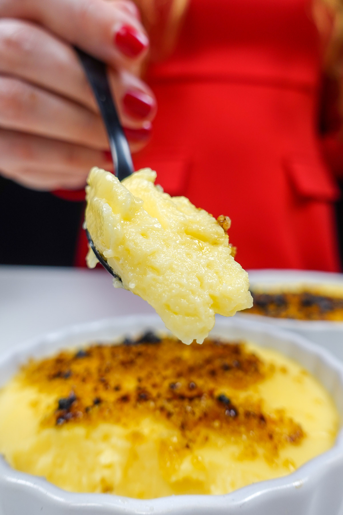 Helena is holding a spoon with Portuguese Custard Cream