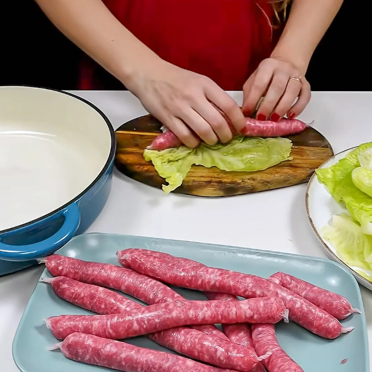 Step 3. Roll the sausages in cabbage
