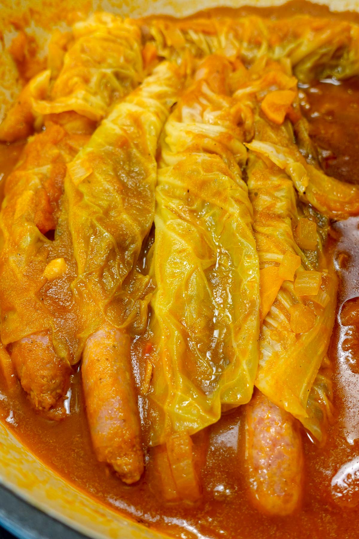 Portuguese Sausages with Cabbage in a dutch oven cooked in sauce