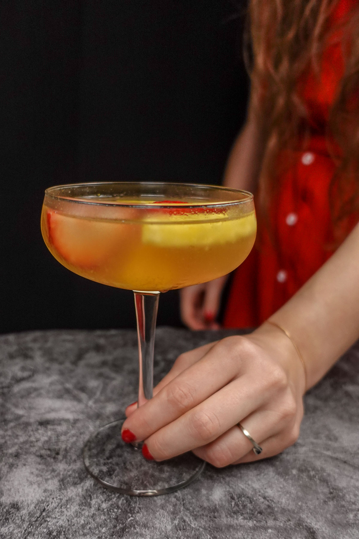 Helena is holding a glass with Portuguese White Sangria