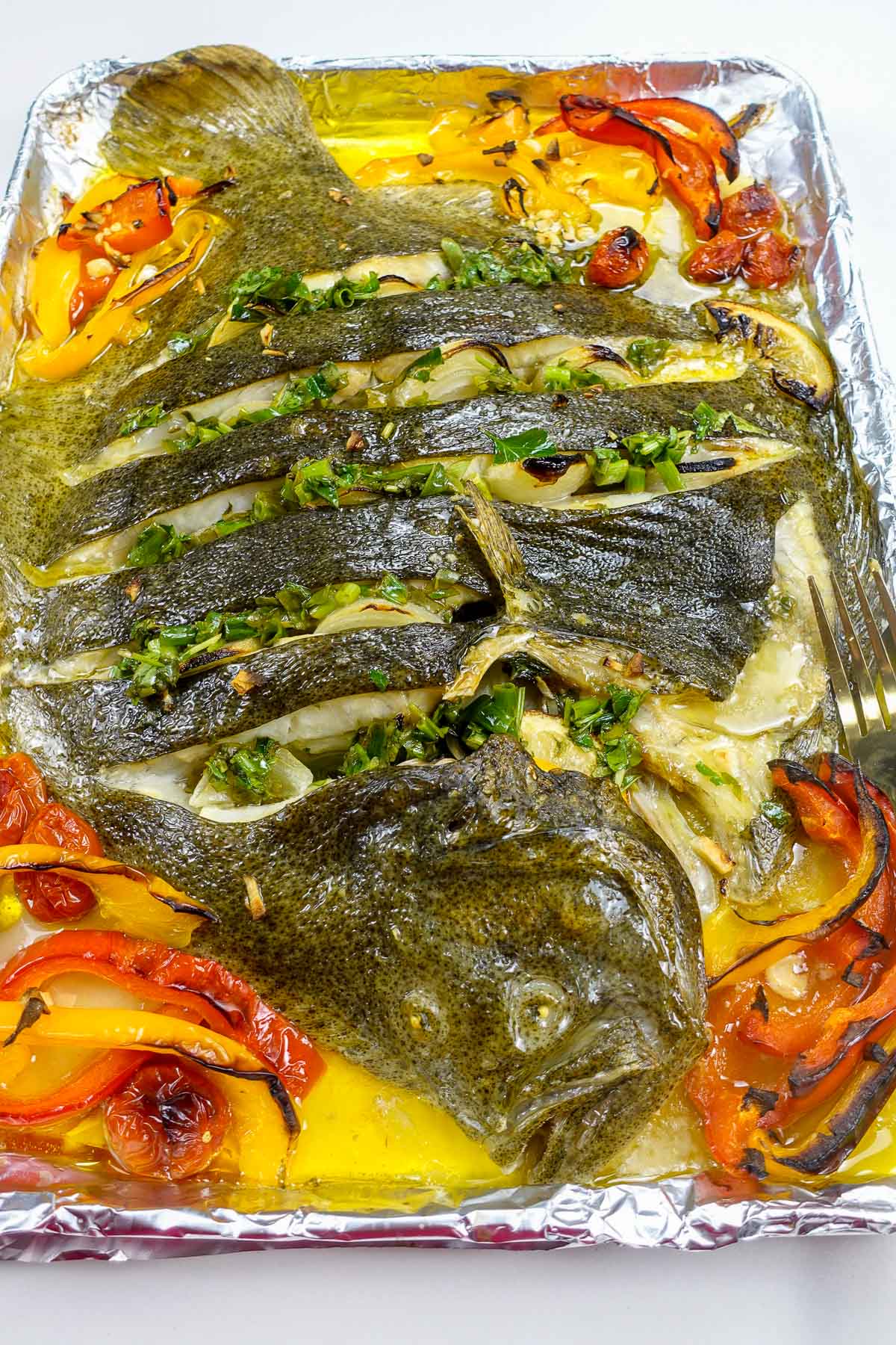 Beautiful oven baked turbot with vegetables on a tray