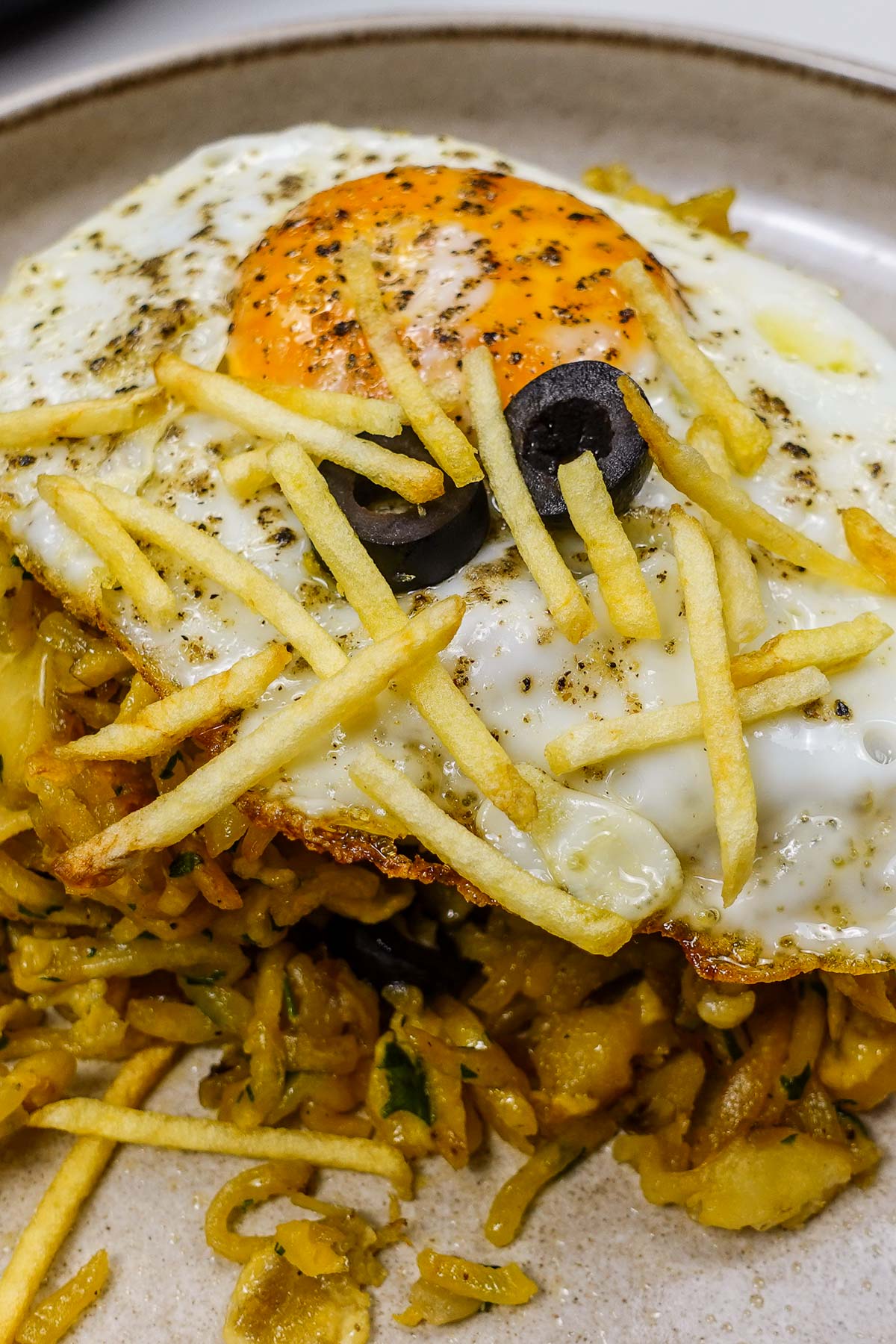 A closeup of salt cod with potatoes and eggs bacalhau a bras