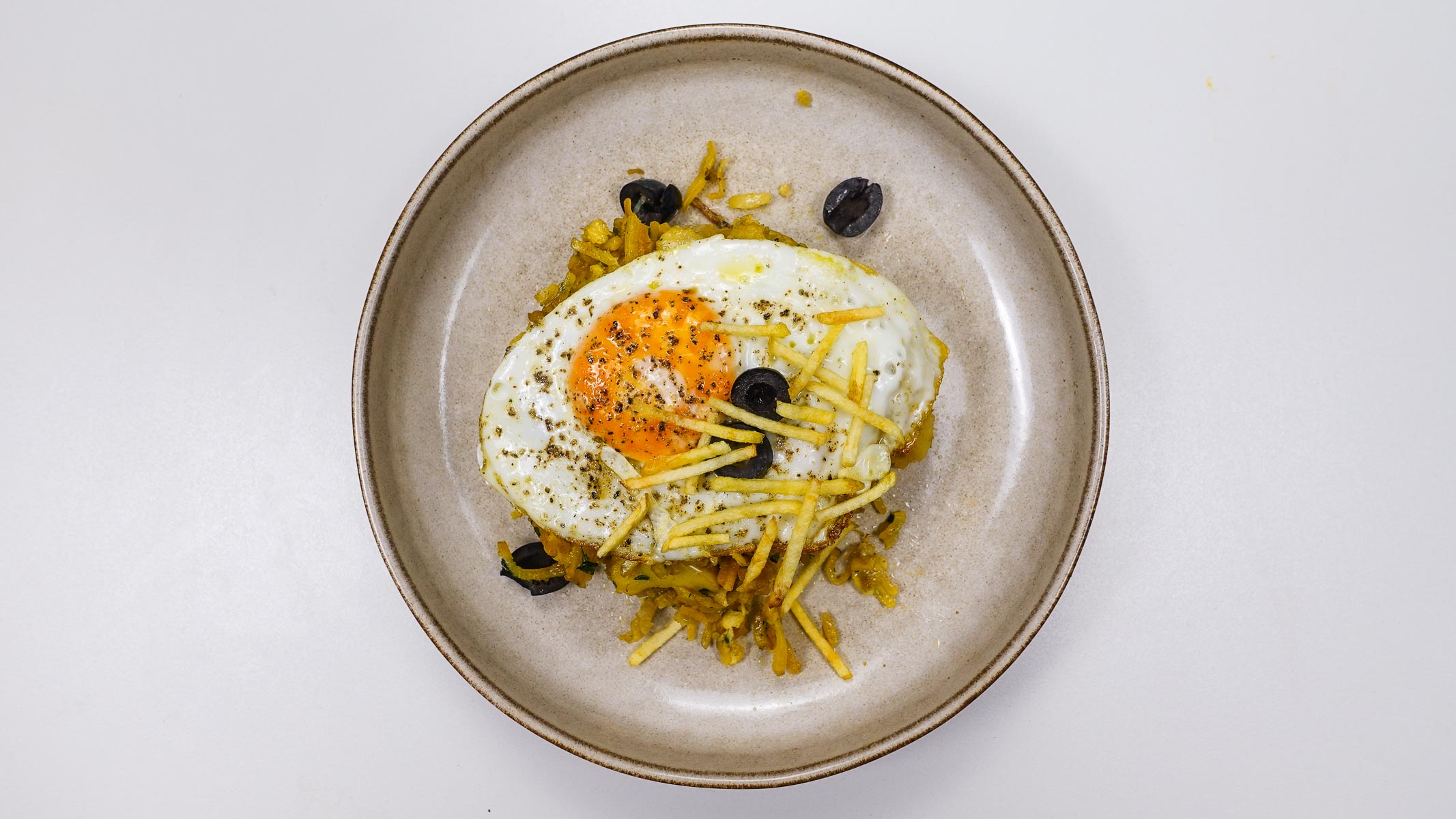 A plate serve with salt cod with potatoes and eggs