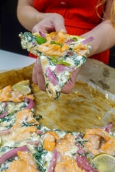 Helena is holding a piece of smoked salmon tart with cottage cheese