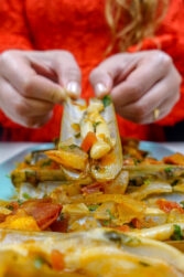 Helena is having one razor clam in tomato sauce in two hands