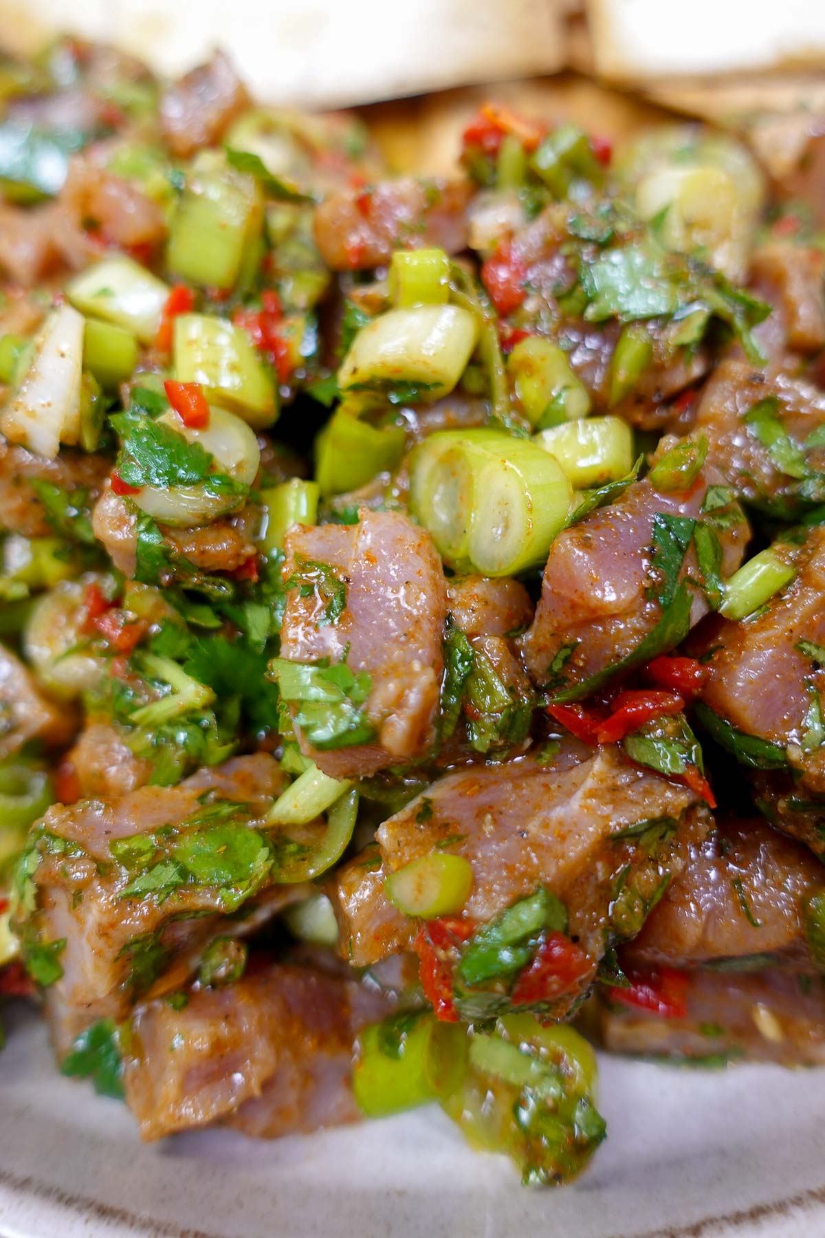 Mediterranean tuna tartare with herbs and chopped vegetables.