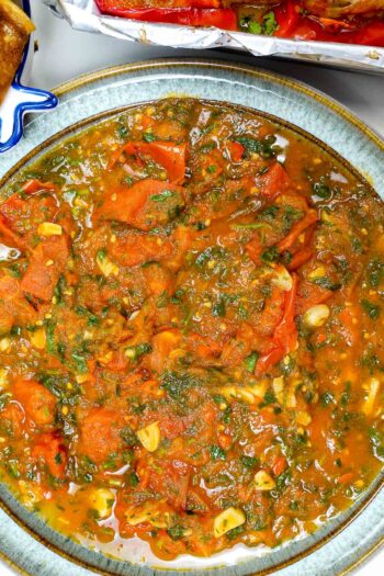 Spicy tomato sauce with cilantro in a ceramic bowl.