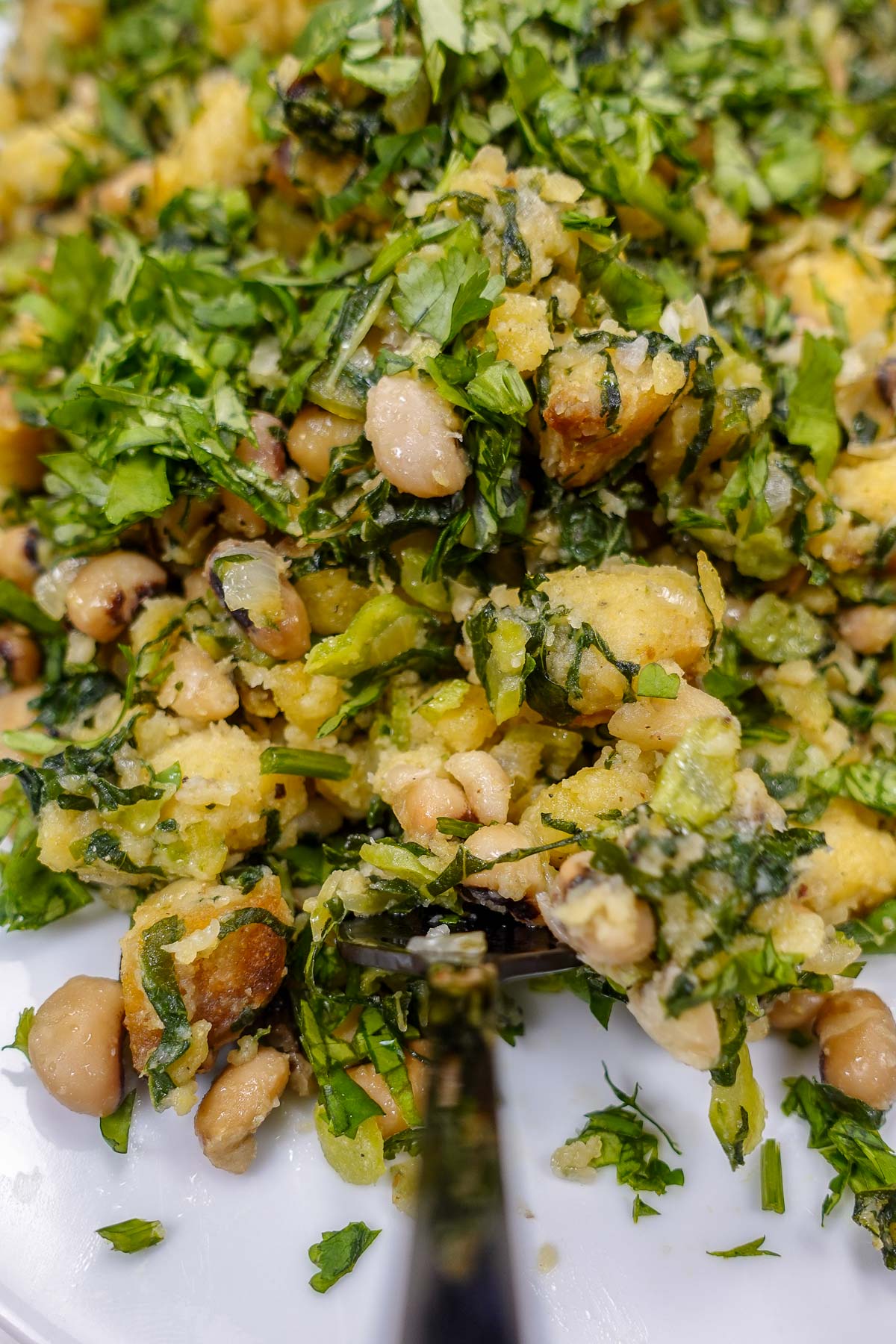 Close-up of black-eyed peas bread mash with fresh herbs.