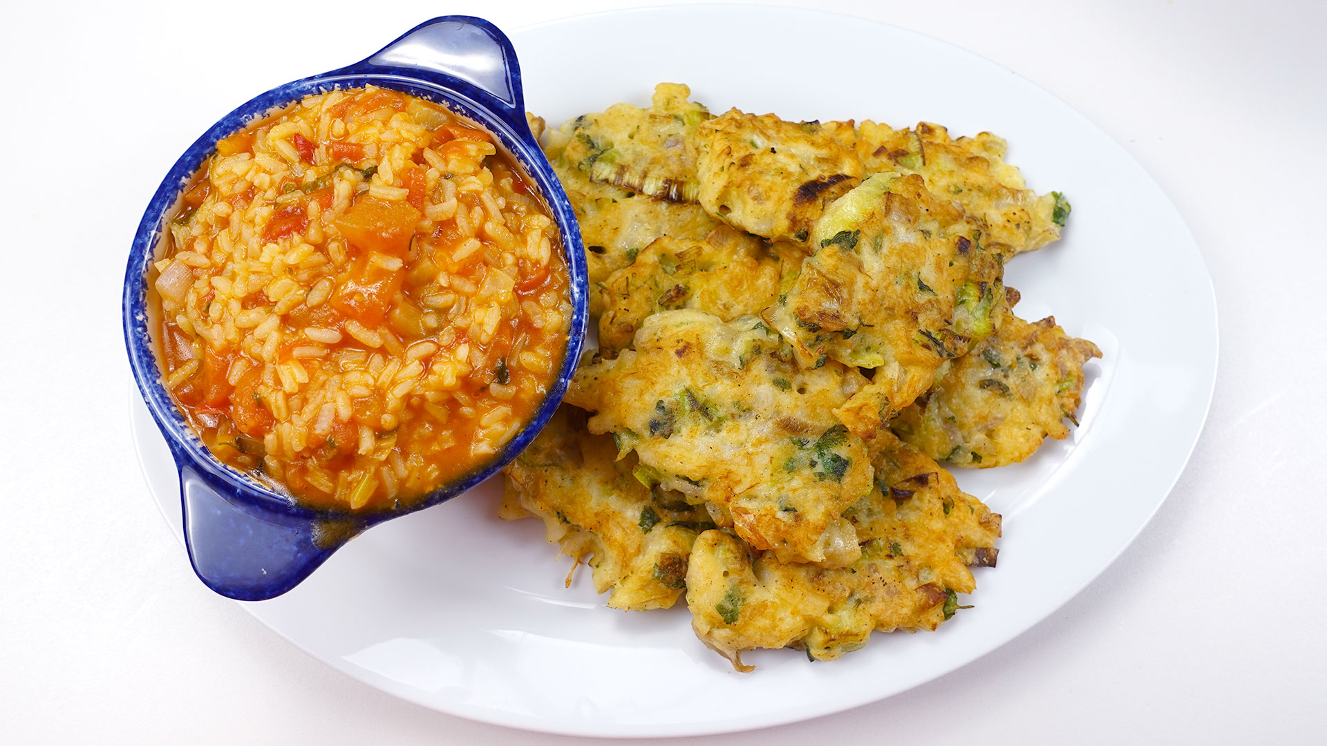 Portuguese tomato rice served with cod cakes